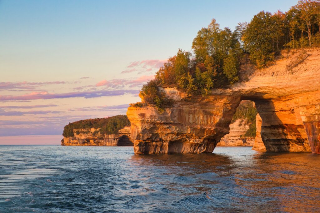Lover's Leap Arch in Pictured Rocks National Lakeshore against scenic sunset